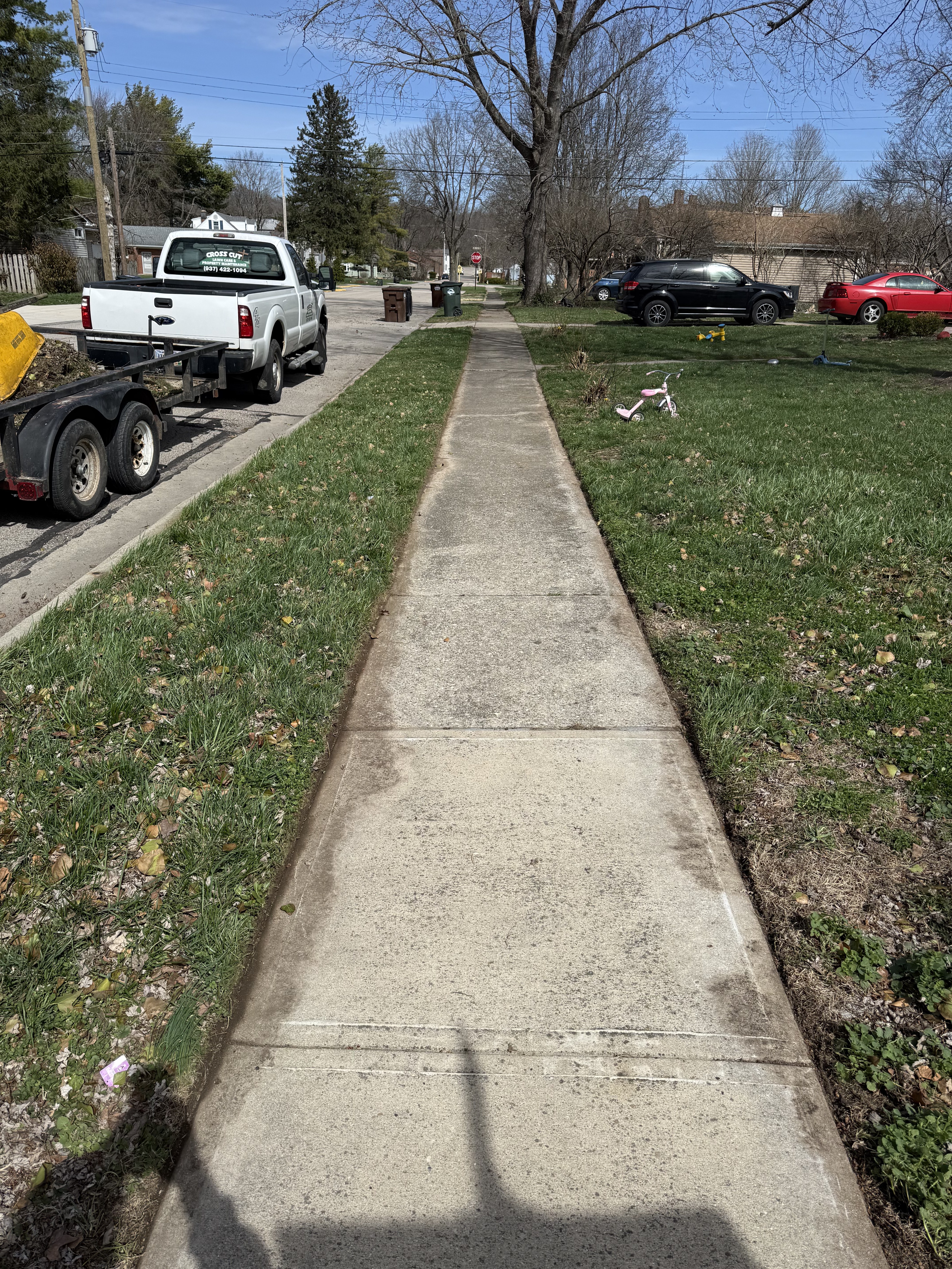 Cleanly edged sidewalk after lawn maintenance