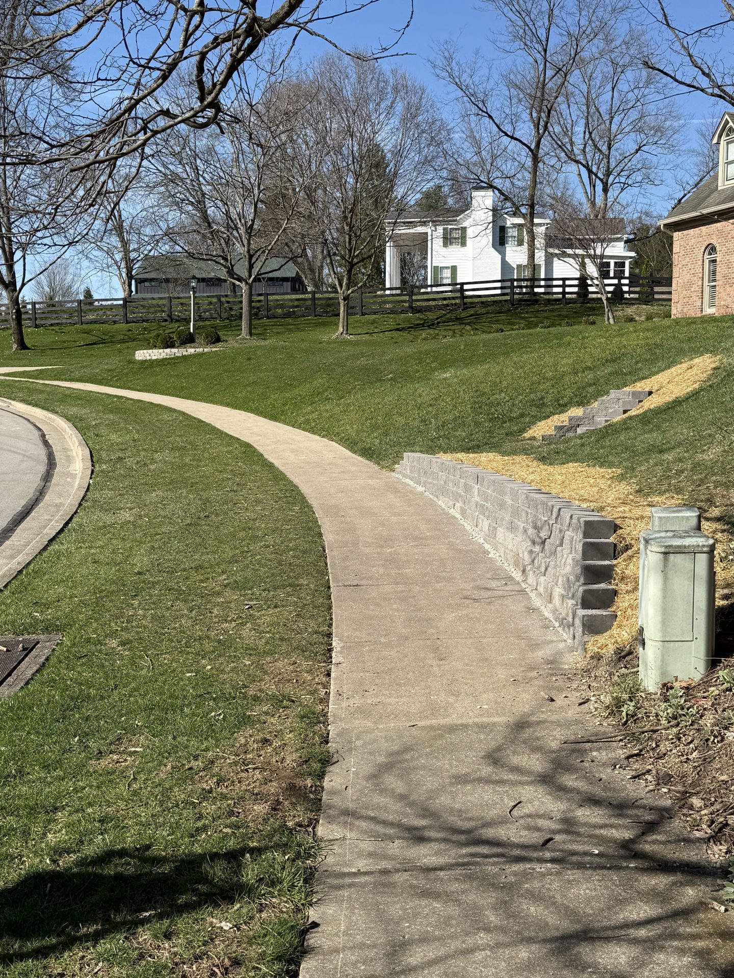 Curved paver walkway leading to a home entrance