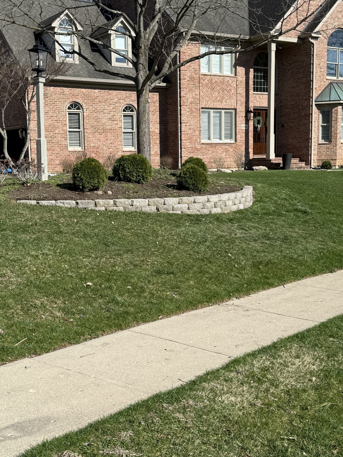 Foundation landscaping with stone edging and walkway
