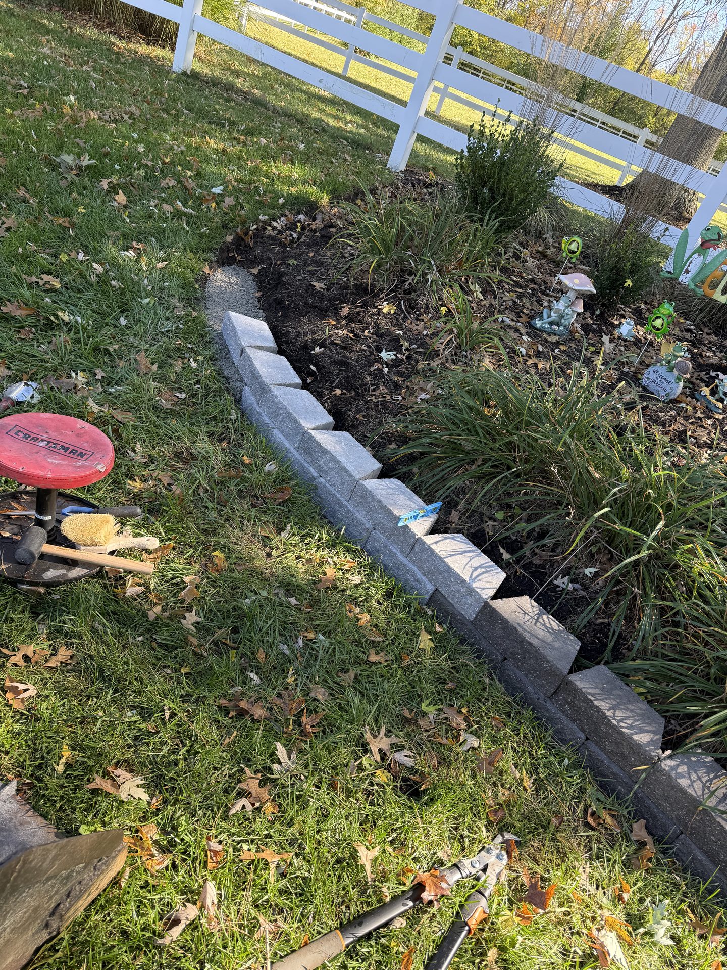 Stone-edged landscape bed with fresh mulch