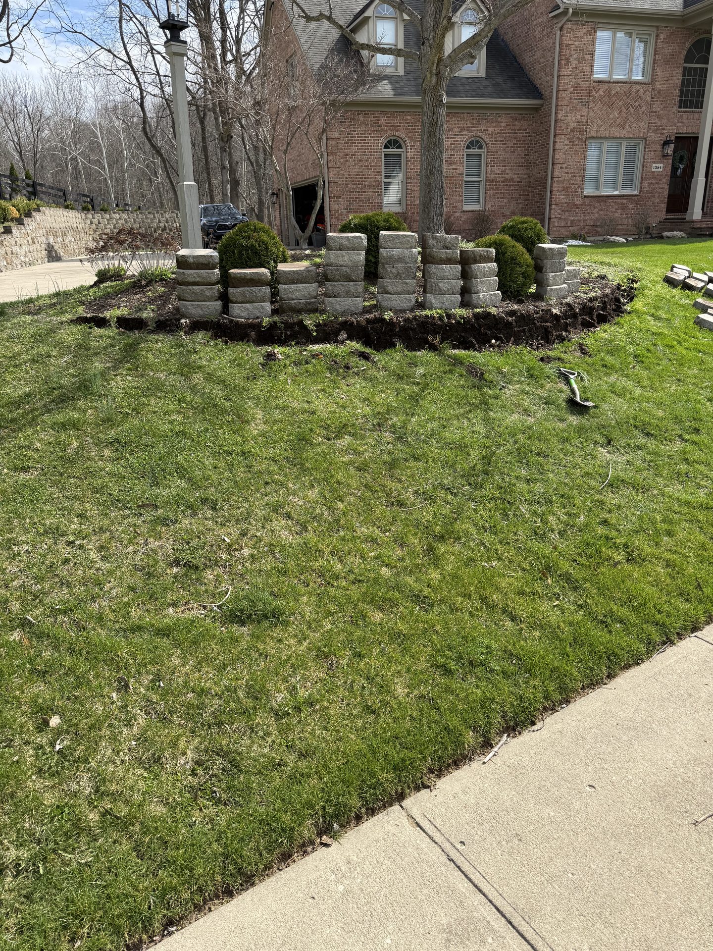 Curved stone retaining wall on a residential slope