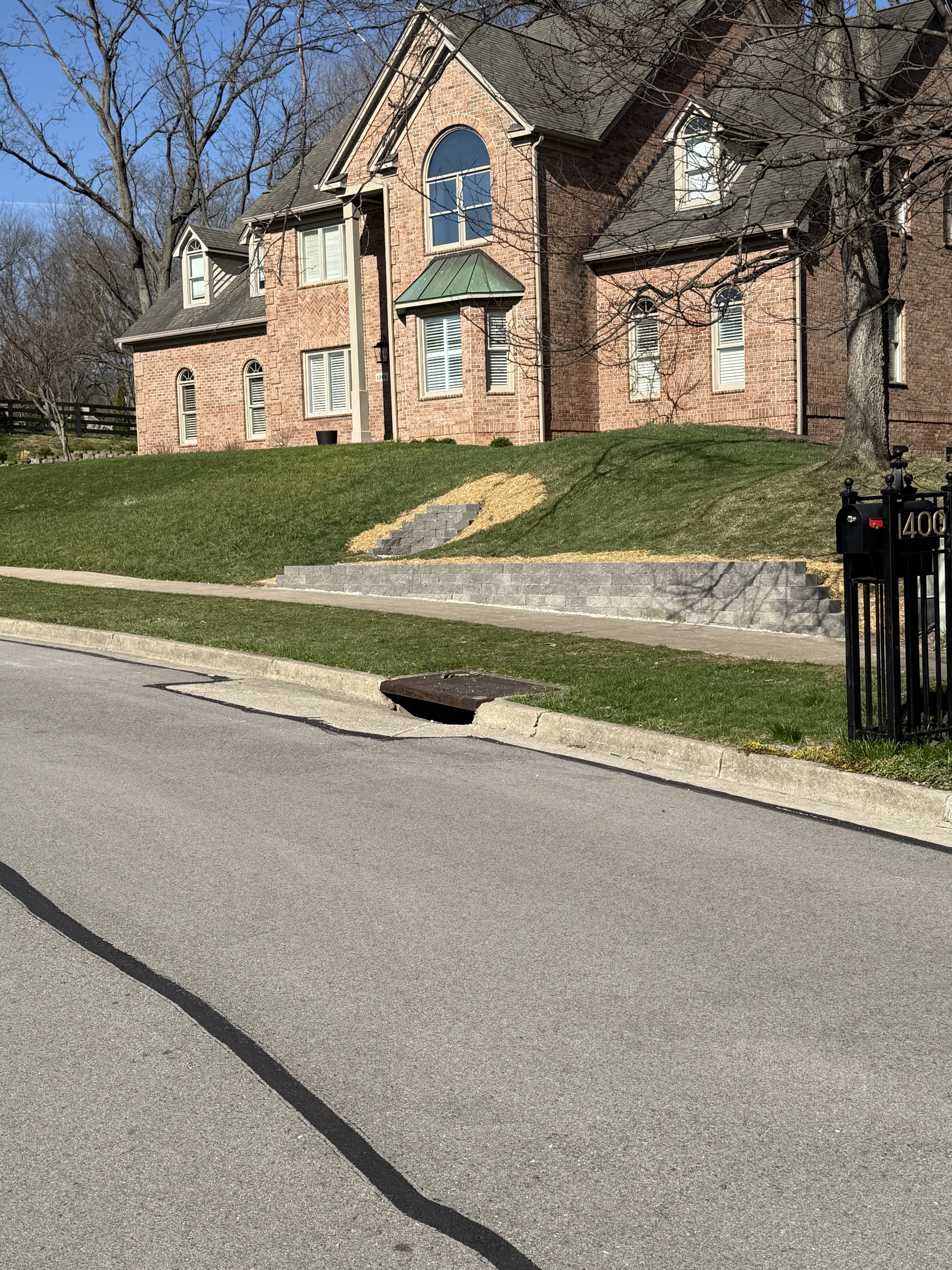 Brick home with completed curved landscape edging