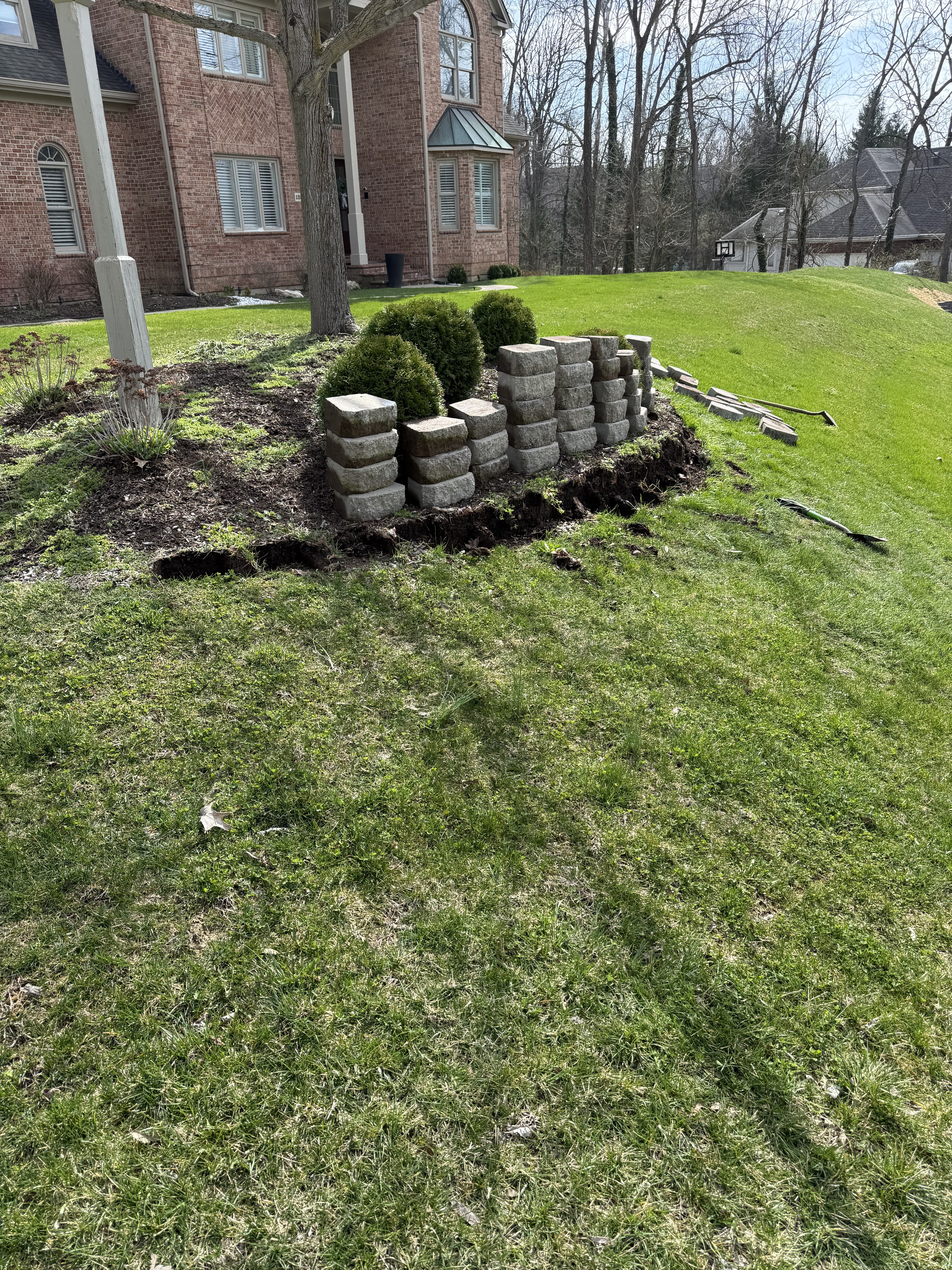 Retaining wall with ornamental grasses and landscape pavers
