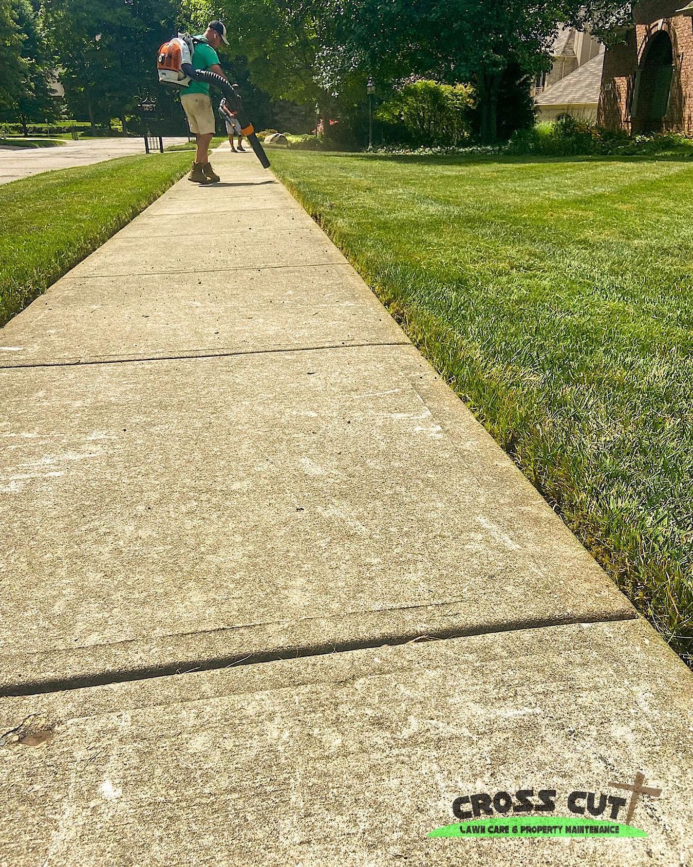 Crew edging a clean sidewalk